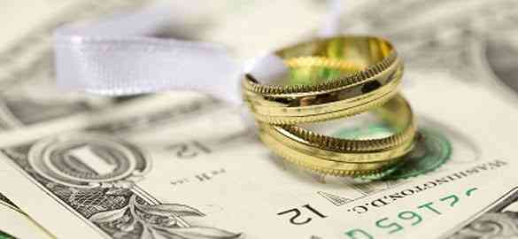 Wedding rings and dollar bill