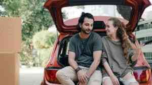 Couple in love sitting on car